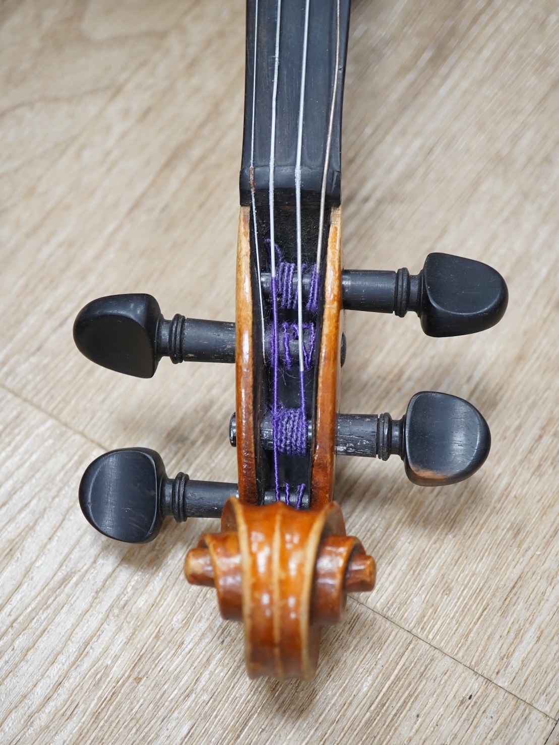 Two cased three quarter size violins, one labelled the London violin Co Ltd, length of back 33.5cm. Condition - both scratched